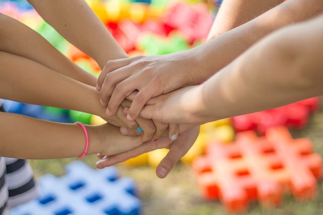 Children’s hands joined together in a circle