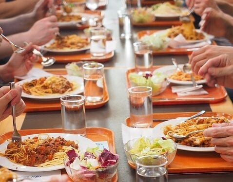 Tables set and dishes served in the school canteen